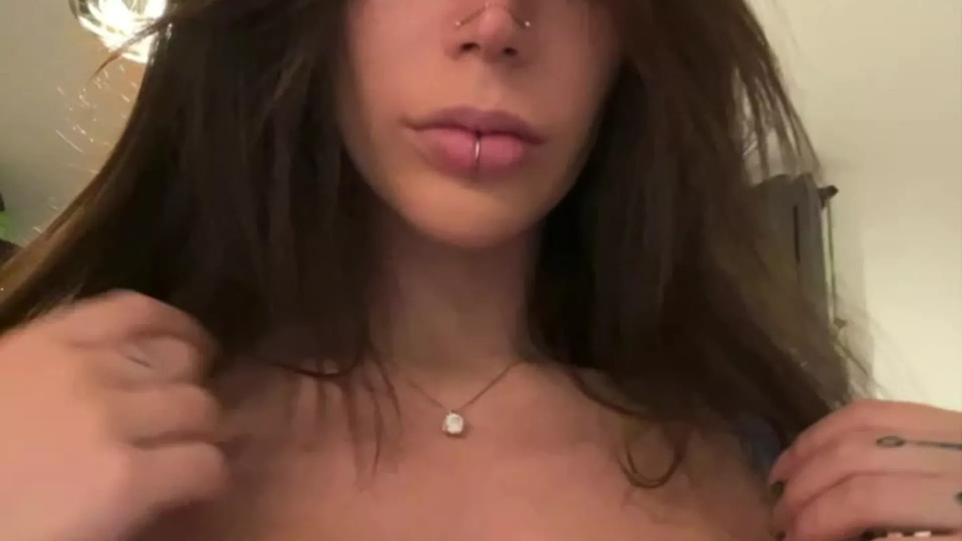 Alex Mucci strips her top to show her big tits