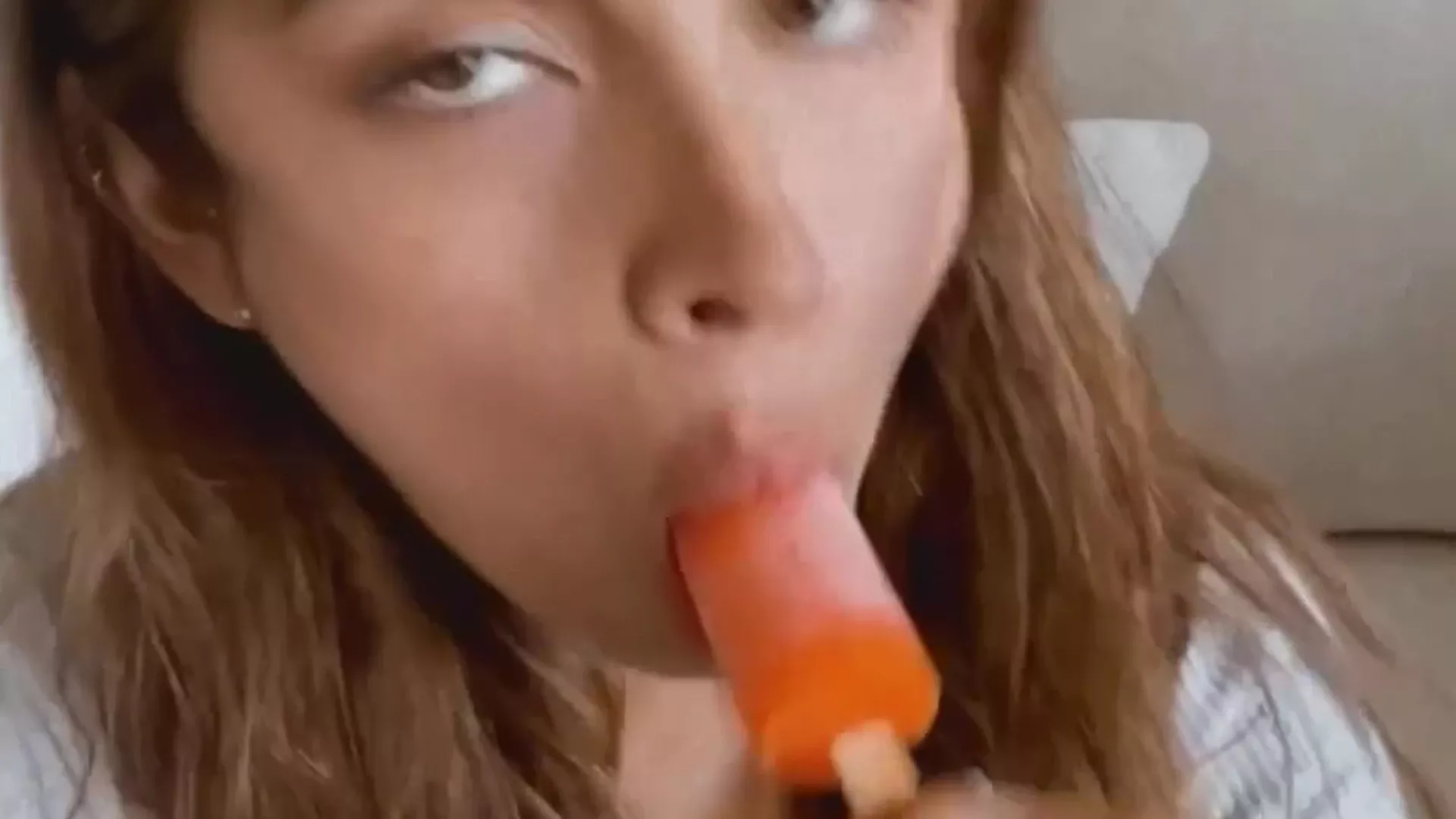 Alex Elena licking a lollypop in onlyfans tease video