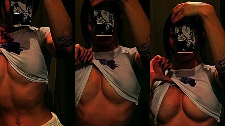 essaere taking a selfie while pulling her top up