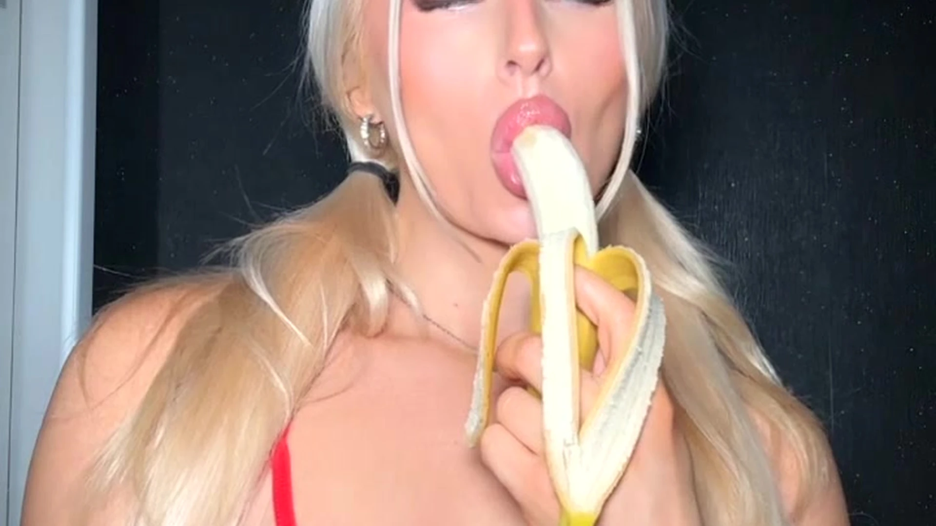 Charlotte Parkes sucking on a banana in a sexy lingerie